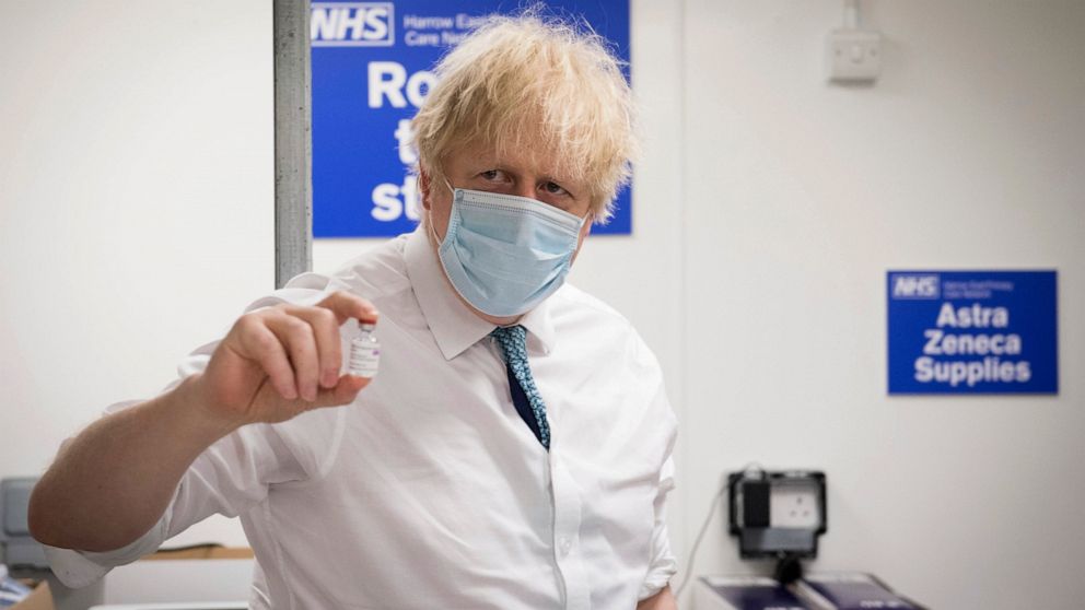 FILE - In this Monday, Jan. 25, 2021 file photo, Britain's Prime Minister Boris Johnson holds a vial of the Oxford AstraZeneca COVID-19 vaccine, during a visit to Barnet FC's ground at the Hive, which is being used as a coronavirus vaccination centre
