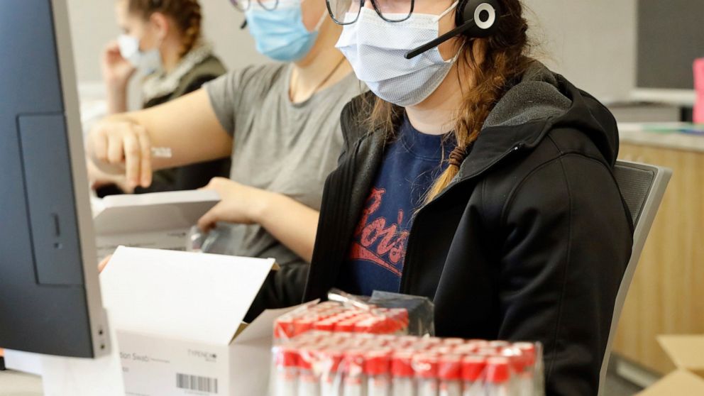 Employees schedule COVID-19 tests and prepare test kits at Primary Health Medical Group's clinic in Boise, Idaho, on Tuesday, Nov. 24, 2020. Troops direct people outside the urgent-care clinic revamped into a facility for coronavirus patients as infe