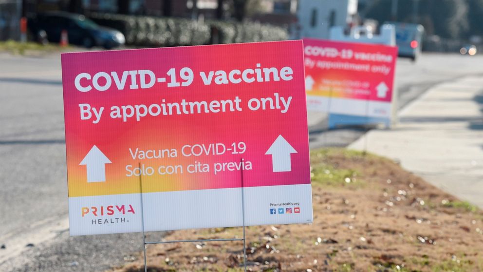Signs line the pathway to a COVID-19 vaccine site operated by PRISMA Health in Columbia, S.C., on Tuesday, Feb. 9, 2021. (AP Photo/Meg Kinnard)
