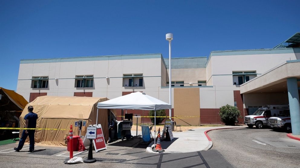 A tent sits in front of the El Centro Regional Medical Center to help process patients with symptoms related to the new coronavirus Wednesday, May 20, 2020, in El Centro, Calif. As much of California inches toward businesses reopening, this farming r