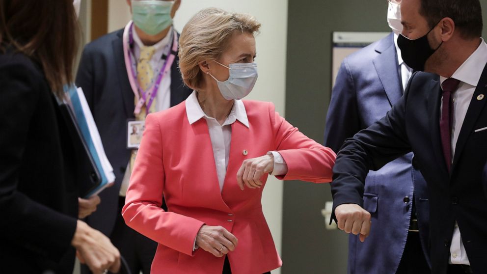 European Commission President Ursula von der Leyen, left, greets Luxembourg's Prime Minister Xavier Bettel with an elbow bump during a round table meeting at an EU summit in Brussels, Friday, July 17, 2020. Leaders from 27 European Union nations meet