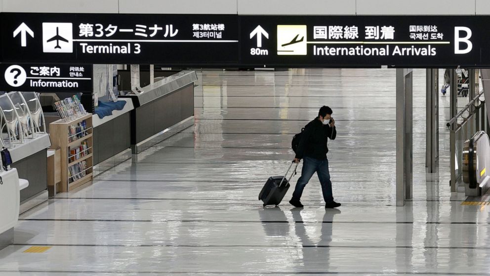 Japan suspends new flight reservations as omicron spreads