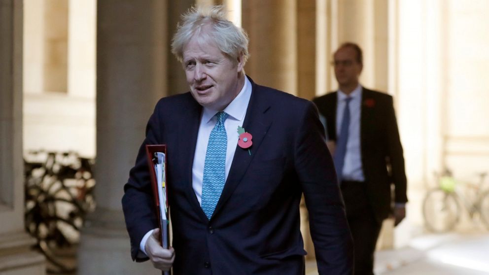 Britain's Prime Minister Boris Johnson walks back towards10 Downing Street following a cabinet meeting in London, Tuesday, Nov. 3, 2020. The Cabinet meeting is held in the Foreign Office to allow for social distancing due to the ongoing Coronavirus p