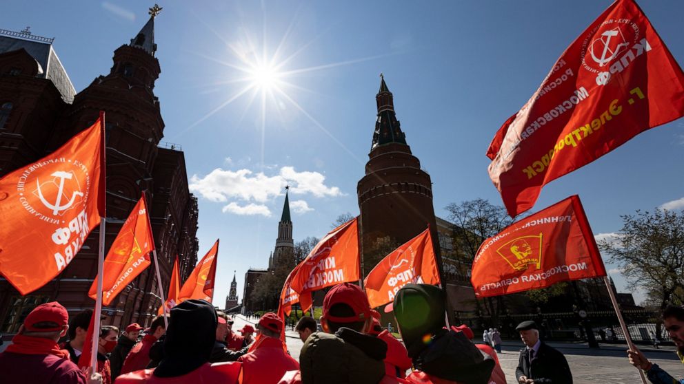 Communists party supporters gather with red flags to mark Labour Day, also knows as May Day near Red Square in Moscow, Russia, Saturday, May 1, 2021. (AP Photo/Alexander Zemlianichenko)