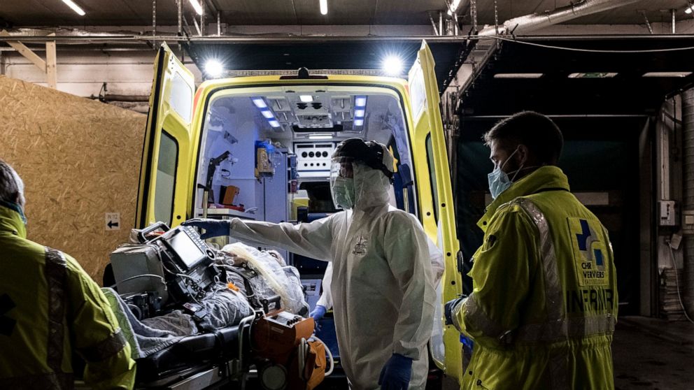 Ambulance crew work as a patient arrives at the CHR CItadelle hospital in Liege, Belgium, Thursday, Oct. 29, 2020. Belgium has announced restrictive measures across the country in an effort to curb the fast-rising tide of COVID-19, coronavirus cases.
