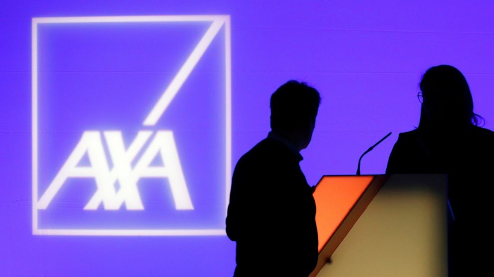 FILE - In this Feb. 21, 2019, file photo, people stand in front of the logo of AXA Group prior to the company's 2018 annual results presentation, in Paris. The Thai affiliate of Paris-based insurance company AXA said Tuesday, May 18, 2021 it is inves