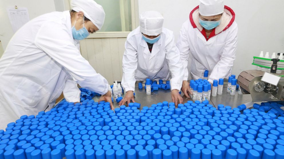 Workers pack bottles of alcohol disinfectant in a factory in Suining in southwest China's Sichuan province Tuesday, Feb. 11, 2020. China's daily death toll from a new virus topped 100 for the first time and pushed the total past 1,000 dead, authoriti
