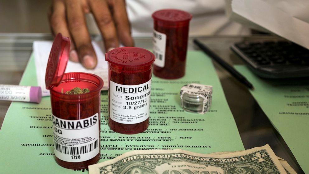 FILE - In this May 14, 2013, file photo, medical marijuana prescription vials are filled at a medical marijuana dispensary in the Venice Beach area of Los Angeles. Attorneys general from 33 states are urging Congress to approve a bill intended to ful