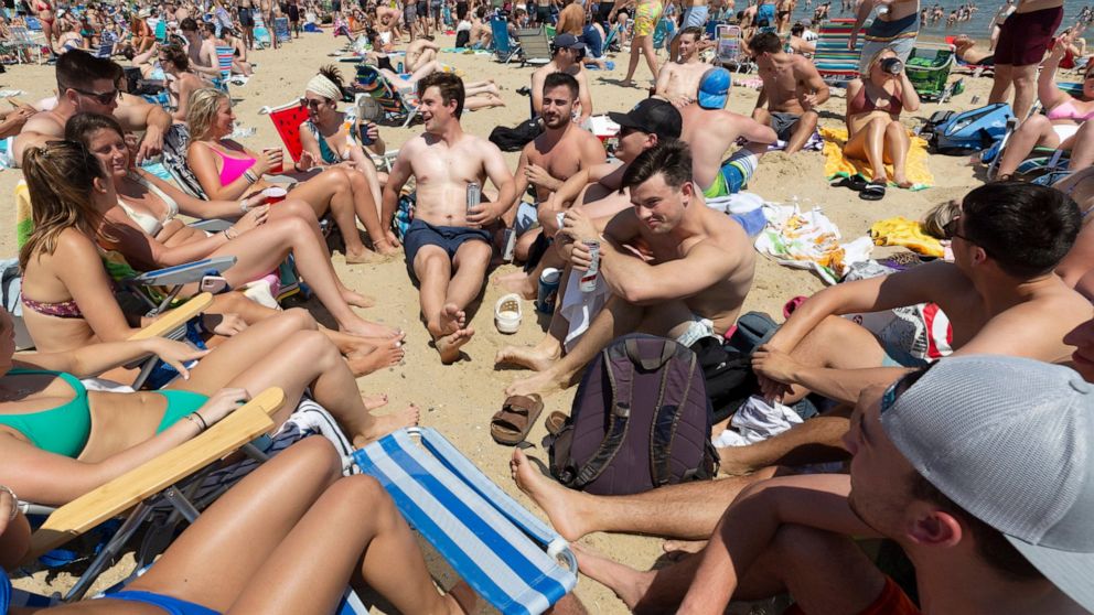Crowds gather on L Street Beach, Saturday, June 5, 2021, in the South Boston neighborhood of Boston. New England is giving the rest of the country a possible glimpse into the future if more Americans get vaccinated. The six-state region has among the