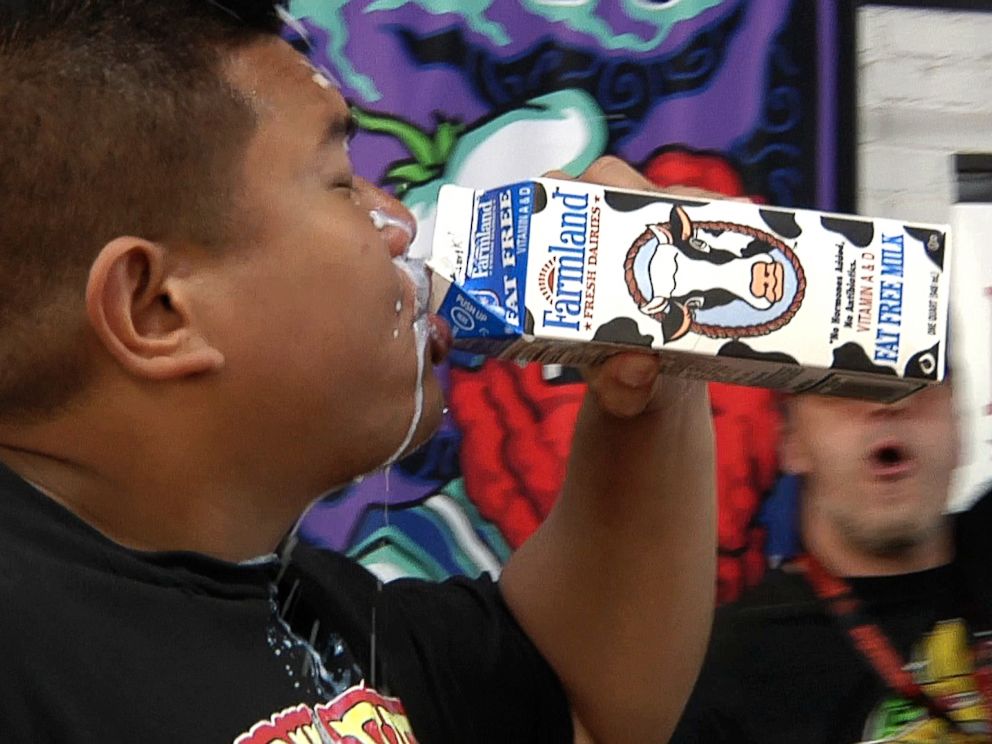 PHOTO: Wayne Algenio washes down nearly 22 Carolina Reaper peppers after winning the Guinness record for the most peppers eaten in 60 seconds.