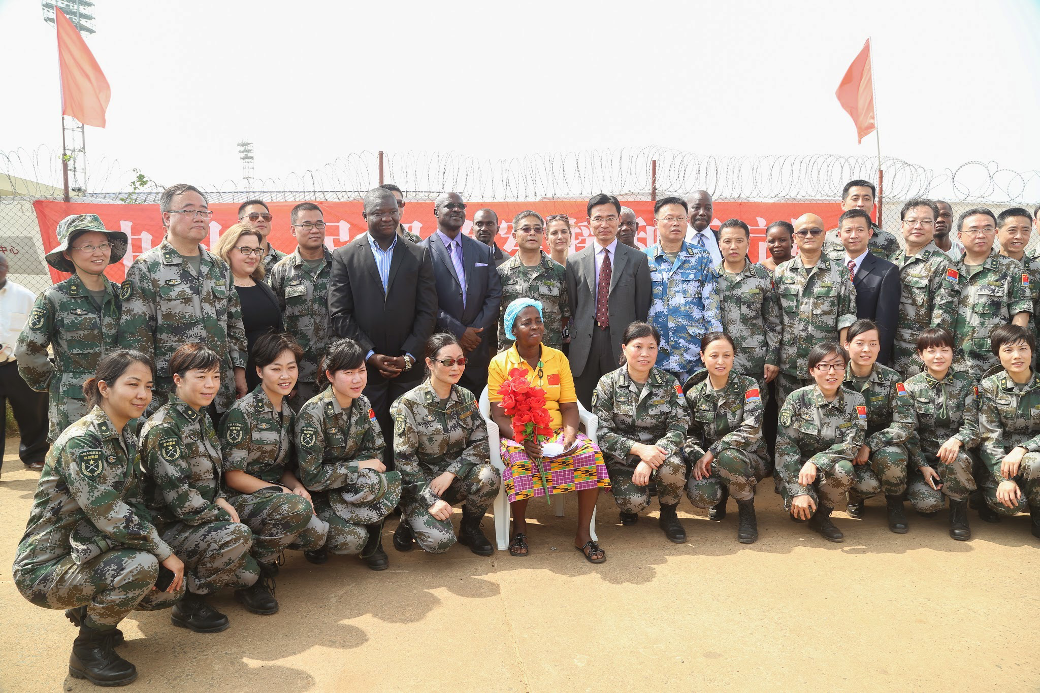 PHOTO: Beatrice Yardolo poses for a photo with Chinese soldiers and officials from the Liberian government, Chinese embassy, and WHO on the day of her release from the Chinese Ebola treatment unit in Monrovia, Liberia on March 5, 2015.