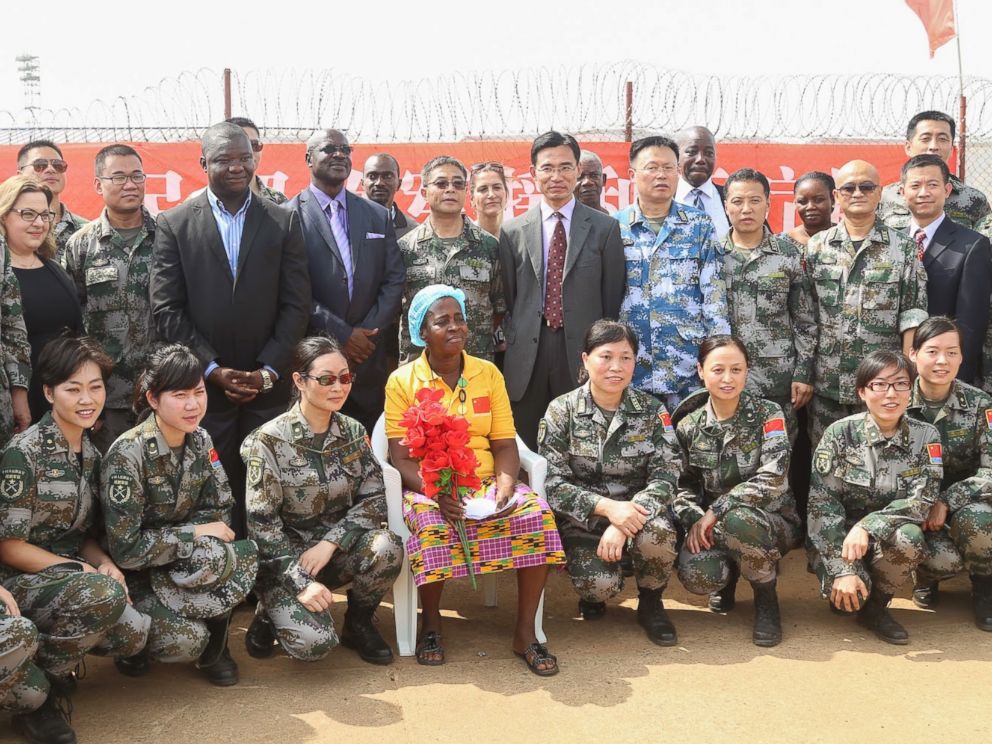 PHOTO: Beatrice Yardolo poses for a photo with Chinese soldiers and officials from the Liberian government, Chinese embassy, and WHO on the day of her release from the Chinese Ebola treatment unit in Monrovia, Liberia on March 5, 2015.
