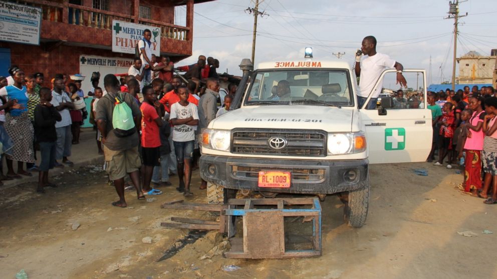 PHOTO: After a Liberian Ebola response team tried and failed to convince three potential patients to go to a treatment center with them, some angry people blocked the ambulance and insisted they would not allow the team to leave without the sick people.