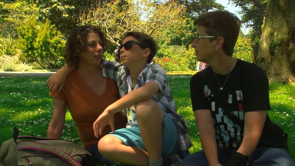 Maddox Rochman-Romdalvik (center) tries EnChroma's glasses for the first time in the San Francisco Botanical Garden.