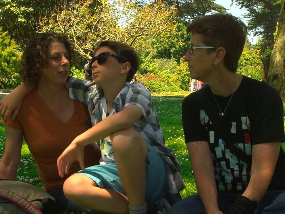 Maddox Rochman-Romdalvik (center) tries EnChromas glasses for the first time in the San Francisco Botanical Garden.