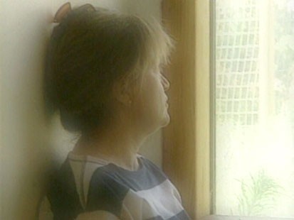 A picture of a woman looking out the window.