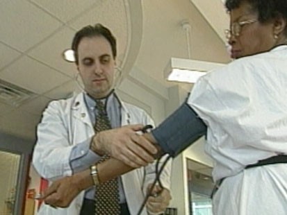 VIDEO: A doctor checking a womans blood pressure