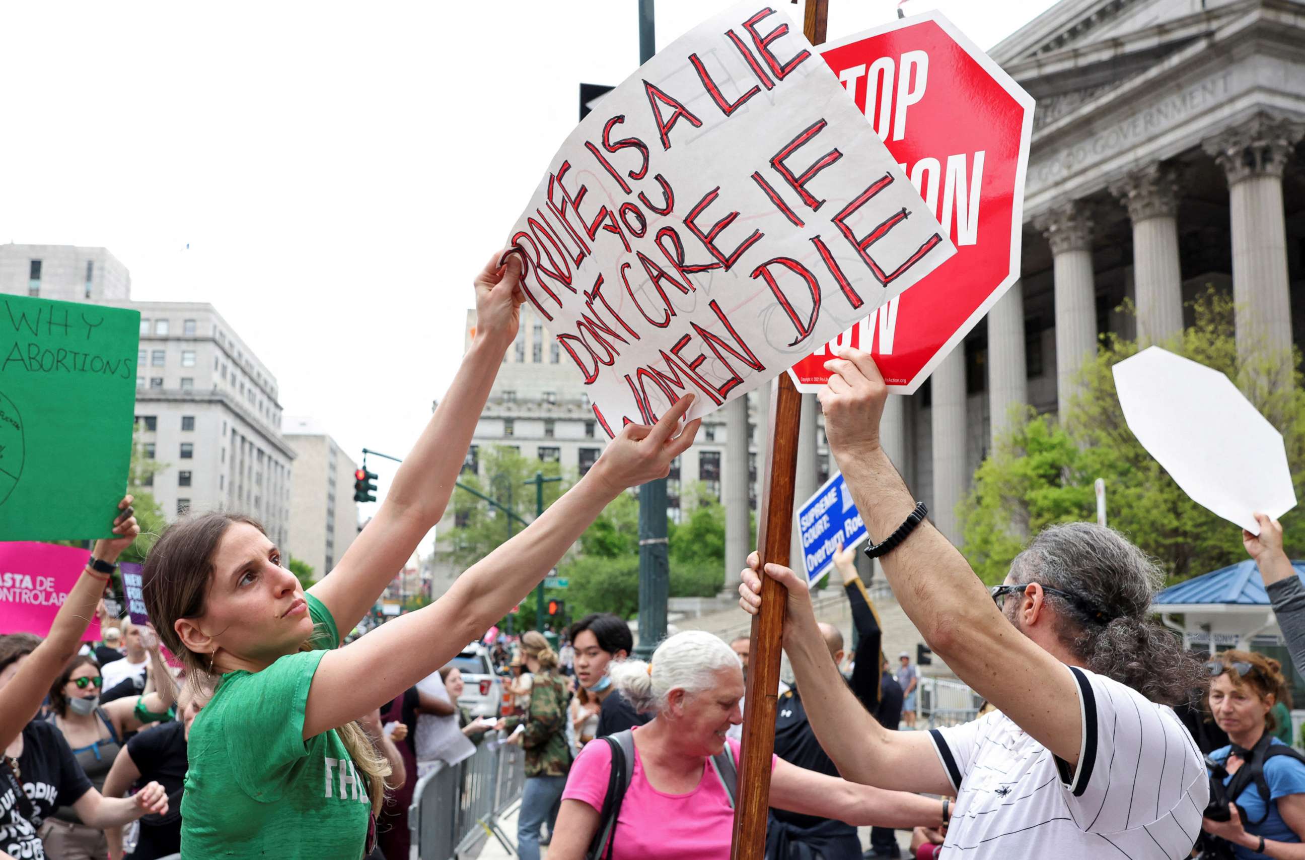 PHOTO:  An abortion rights protester holds a placard in front of an anti-abortion protester during demonstrations following the leaked Supreme Court opinion suggesting the possibility of overturning Roe v. Wade, in New York, May 14, 2022.