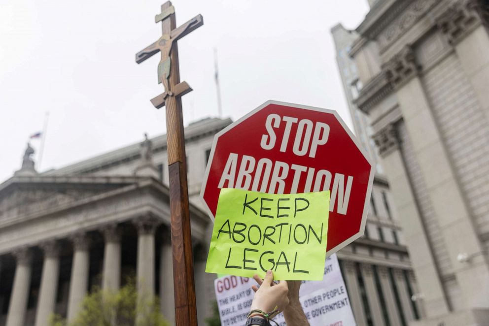 PHOTO: Anti-abortion and pro-choice demonstrators hold signs outside Manhattan federal court during an abortion-rights demonstration, May 14, 2022, in New York.