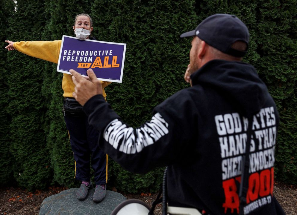 PHOTO: Abortion rights demonstrator Stacy Holloway and anti-abortion demonstrators protest outside Northland Family Planning in Westland, Mich., on Nov. 5, 2022.