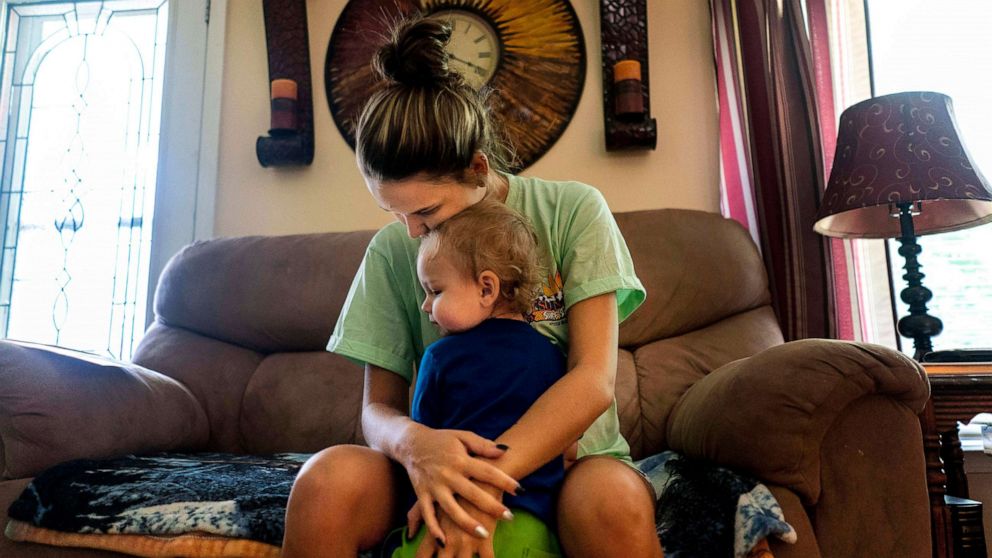 PHOTO: A mother recovering from an opioid addiction holds her son at their home in a remote area where prescription opioids addiction has greatly affected communities like Big Stone Gap, Va., July 22, 2019.