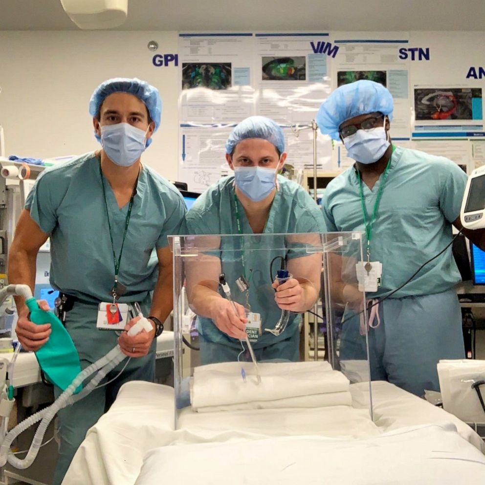 PHOTO: Anesthesiologists at Rush University Medical Center in Chicago display the aerosol box used to protect medical workers during intubations of COVID-19 patients.
