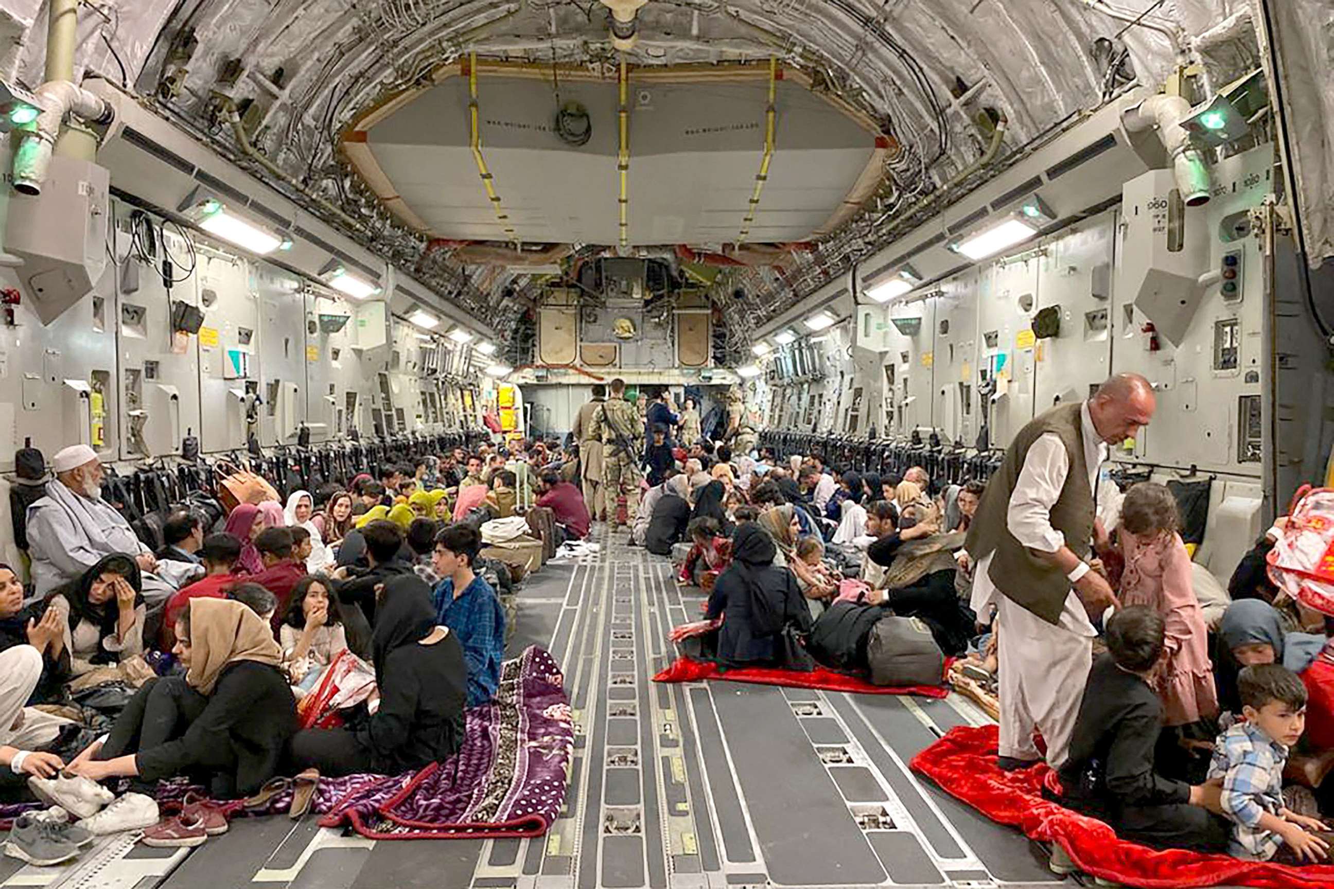 PHOTO: Afghan people sit inside a U.S military aircraft to leave Afghanistan, at the military airport in Kabul on Aug. 19, 2021 after Taliban's military takeover of Afghanistan. 