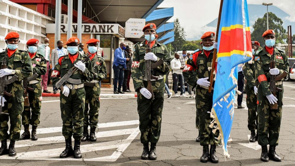 PHOTO: Congolese soldiers carry their national flag during parade at Goma airport as the new military governor arrives to take charge in Goma, North Kivu province, in the Democratic Republic of Congo, May 10, 2021.