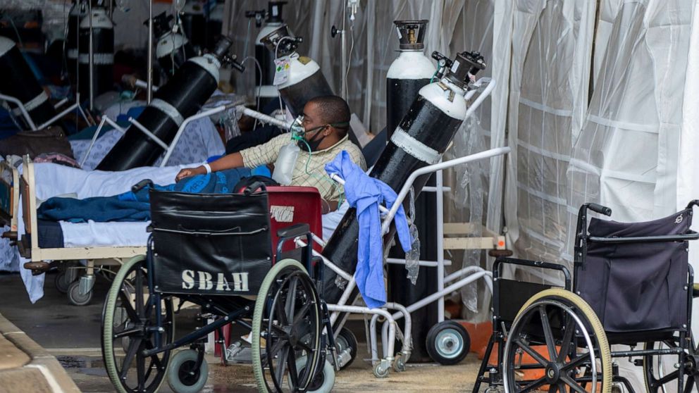 PHOTO: A patient wearing an oxygen mask is treated in a makeshift emergency unit at Steve Biko Academic Hospital in Pretoria, South Africa, Jan. 11, 2021.