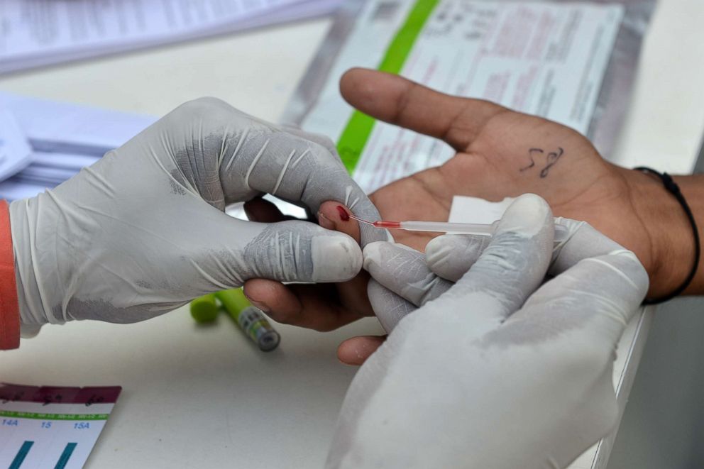 PHOTO: A nurse carries out a test for HIV/AIDS during an event to mark International Condom Day in New Delhi, Feb. 13, 2018.