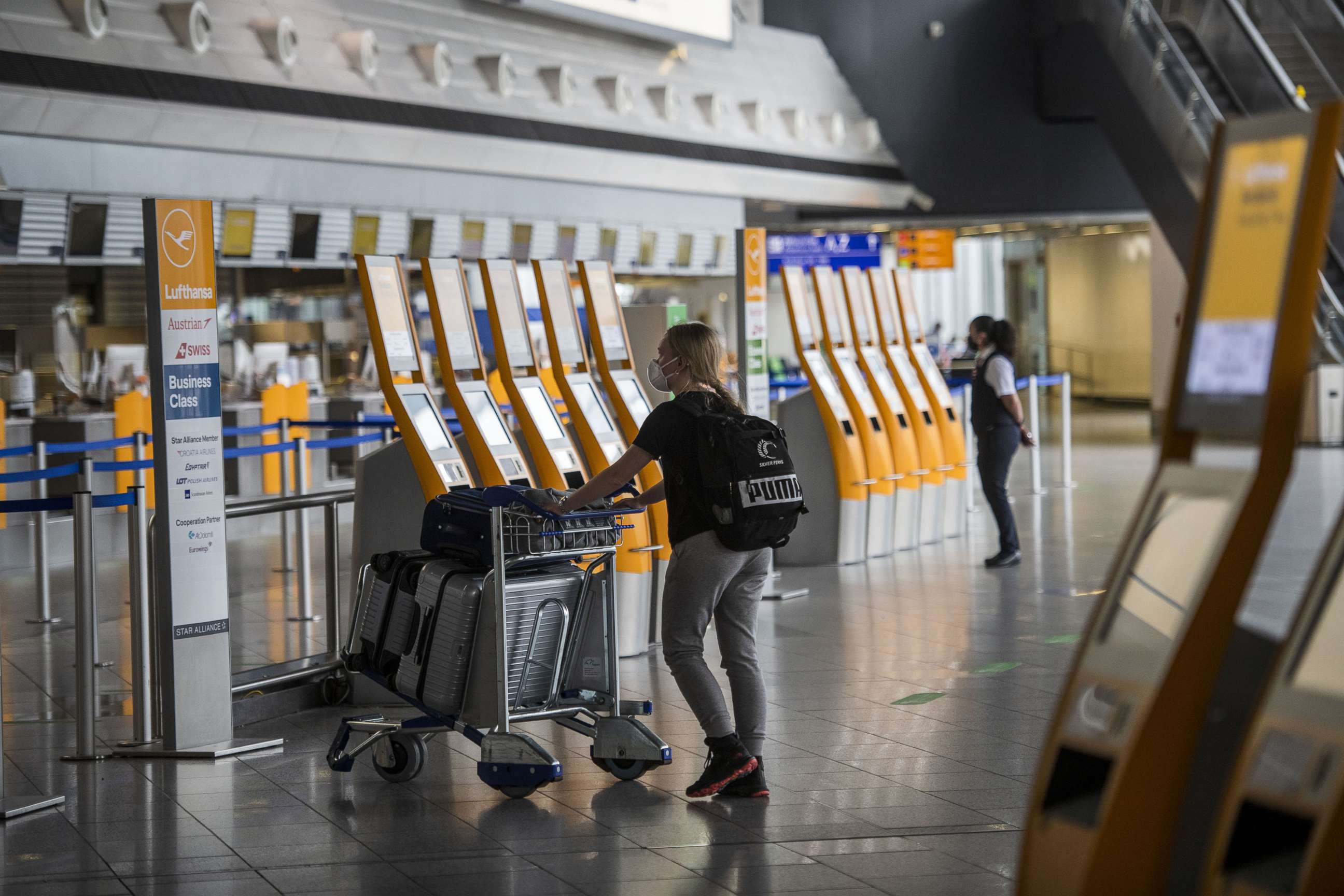 PHOTO: A passenger walks to Lufthansa check in counter at Frankfurt Airport during the novel coronavirus pandemic, June 15, 2020, in Frankfurt am Main, in Germany.