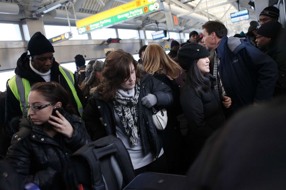 PHOTO: Passengers attempt to board an over crowded AirTrain at John F. Kennedy Airport on Jan. 27, 2011 in New York.