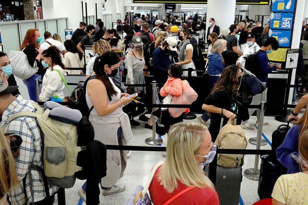 PHOTO: People wait in the line to clear through the TSA checkpoint at Miami International Airport on Nov. 24, 2021, in Miami.