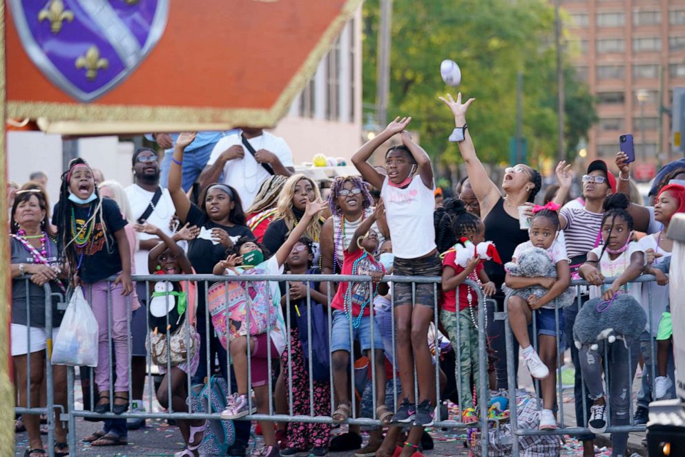 PHOTO: A crowd attends the "Tardy Gras" parade in Mobile, Ala., May 21, 2021.