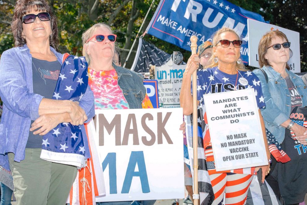 PHOTO: People demonstrates against face masks, vaccines, and pandemic closures near the residence of Massachusetts governor Charlie Baker in Swampscott, Mass., Sept. 26, 2020.