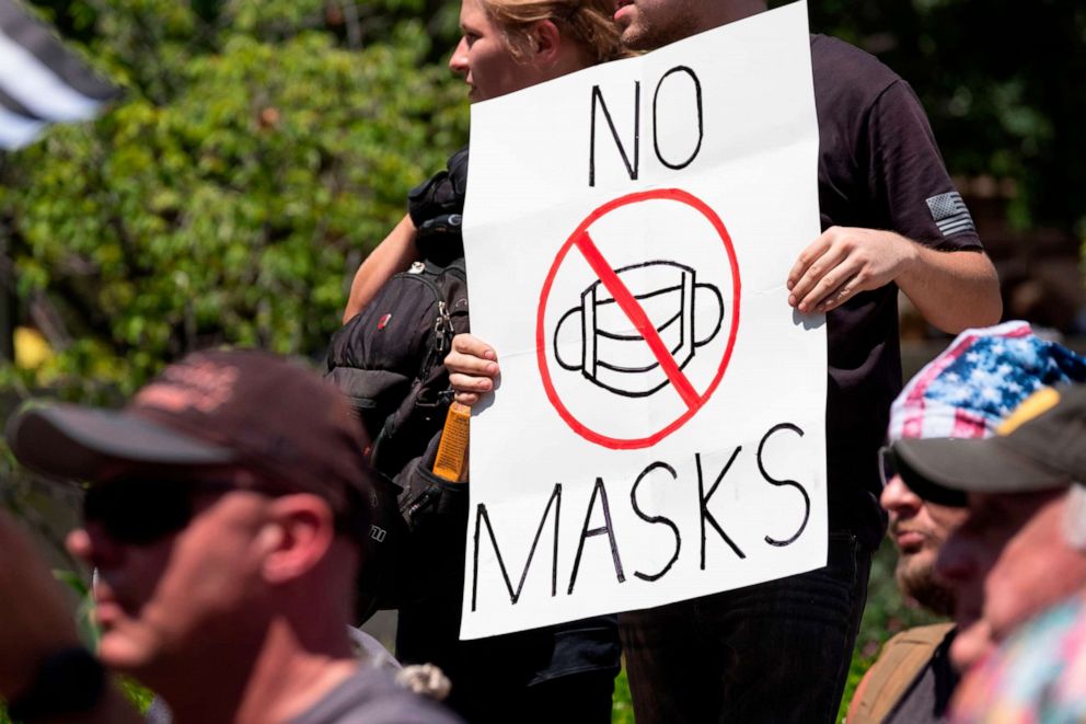 PHOTO: An anti-mask protestor holds up a sign in front of the Ohio Statehouse during a right-wing protest "Stand For America Against Terrorists and Tyrants" at State Capitol on July 18, 2020 in Columbus, Ohio.