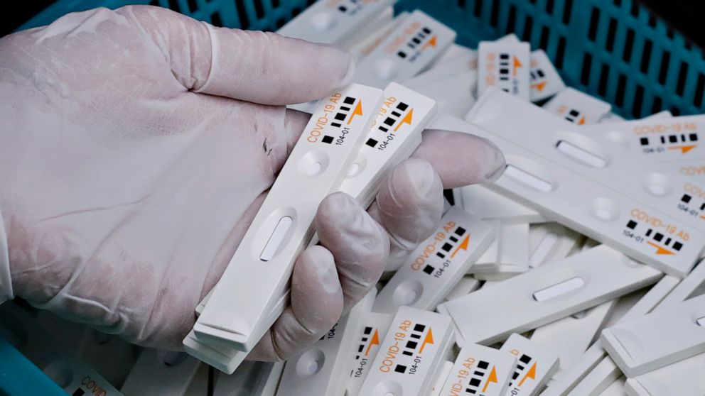 PHOTO: An employee holds antibody test cartridges of the ichroma COVID-19 Ab testing kit used in diagnosing the coronavirus on a production line of the Boditech Med Inc., in Chuncheon, South Korea, April 17, 2020.