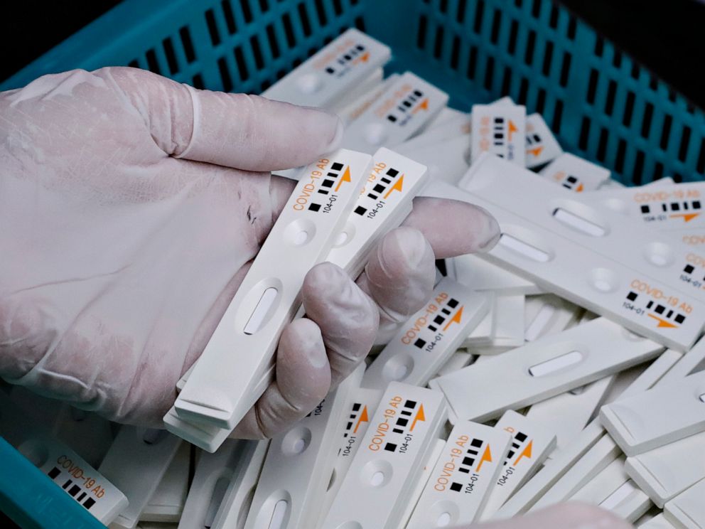 PHOTO: An employee holds antibody test cartridges of the ichroma COVID-19 Ab testing kit used in diagnosing the coronavirus on a production line of the Boditech Med Inc., in Chuncheon, South Korea,  April 17, 2020.