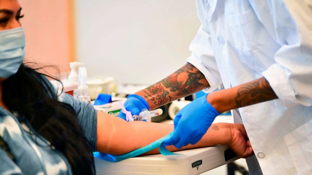 PHOTO: A phlebotomist draws blood during a no-cost Covid-19 antibody testing organized by the GuardHeart Foundation and the City of Pico Rivera, Feb. 17, 2021, in Pico Rivera, California.