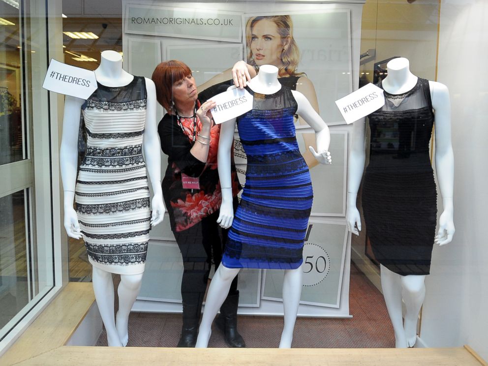 PHOTO: Shop manager Debbie Armstrong adjusts a two tone dress in a window display of a shop in Lichfield, England on Feb. 27, 2015.