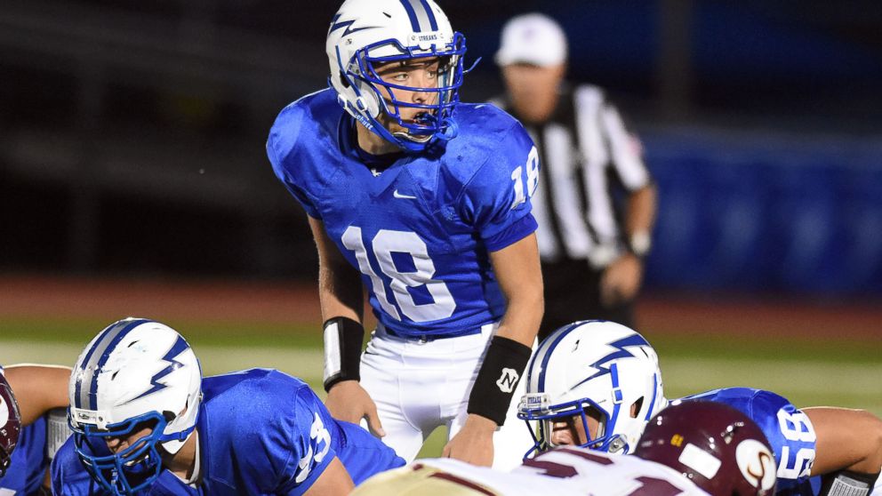 In this Sept. 25, 2015 photo, Warren Hills Regional High School quarterback Evan Murray looks over the Summit defense in Washington, N.J. 