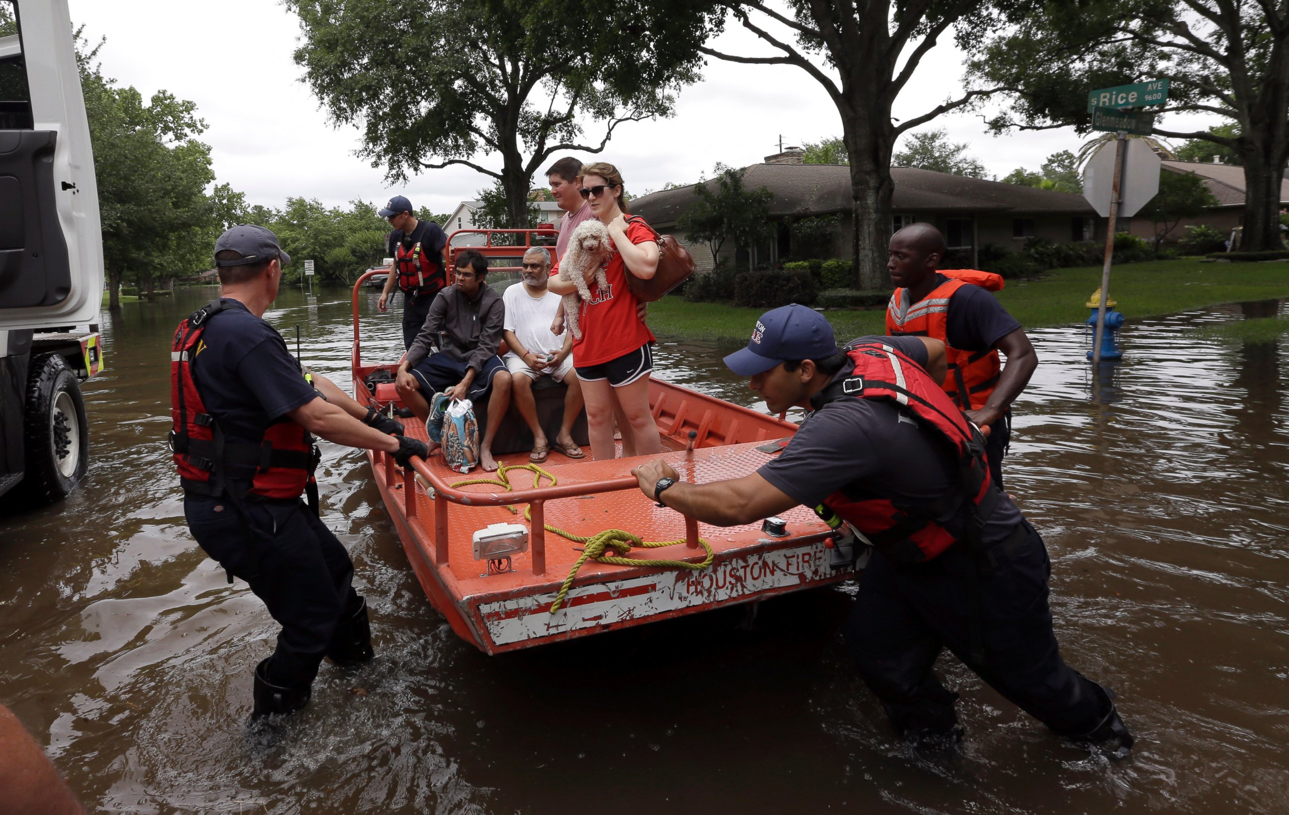 PHOTO: Members of the Houston Fire department help residents evacuate through the floodwaters surrounding their homes in Houston, May 26, 2015.