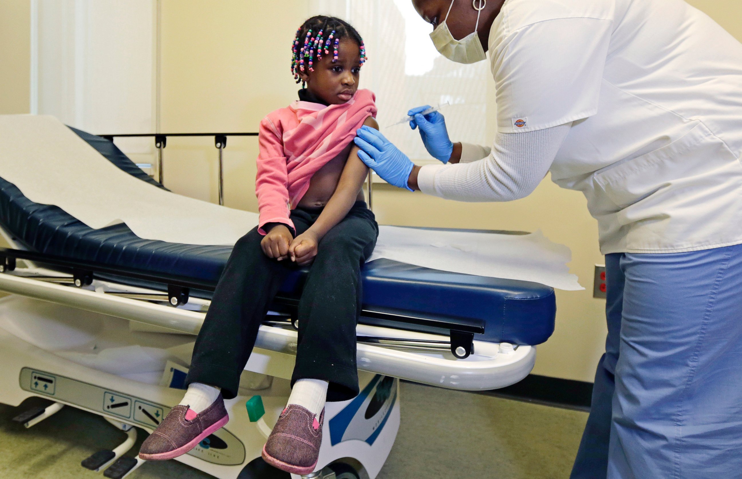 PHOTO: Four-year-old Gabriella Diaz sits as a nurse administers a flu shot at the Whittier Street Health Center in Boston, Mass. on Jan 9, 2013.