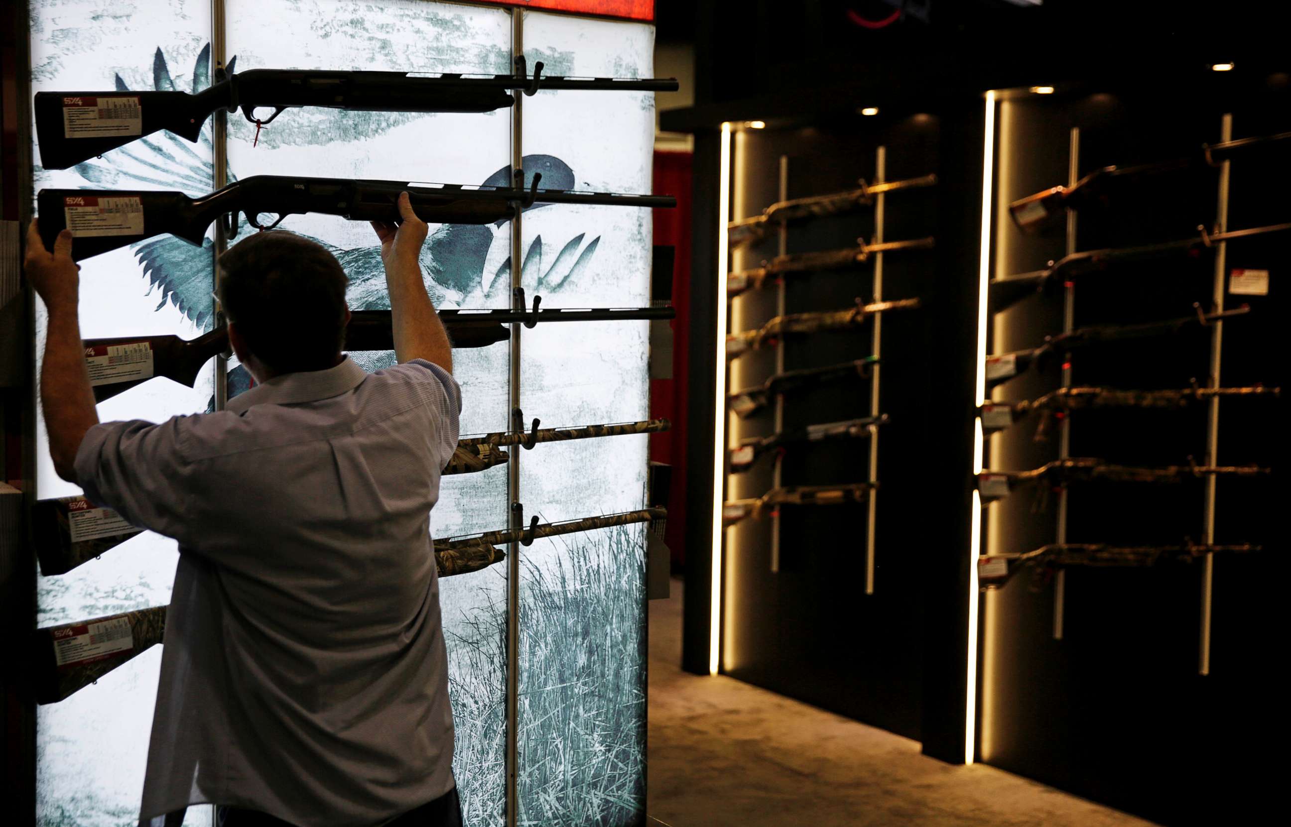 PHOTO: A man looks at a gun on display at the NRA annual convention where President Donald Trump spoke, in Atlanta, Friday, April 28, 2017. 