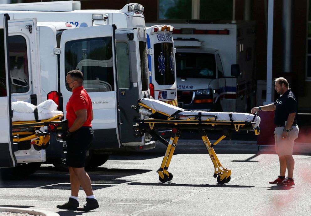 PHOTO: Medical transports and ambulances are parked outside the emergency-room entrance at Banner Desert Medical Center, June 16, 2020, in Mesa, Ariz.