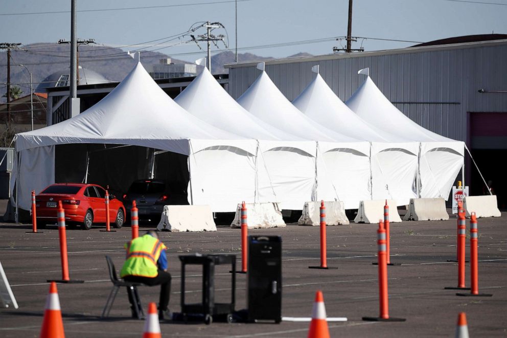 PHOTO: Cars line up as they prepare for coronavirus (COVID-19) testing at a site erected near the Arizona Veterans Memorial Arena, April 27, 2020, in Phoenix.