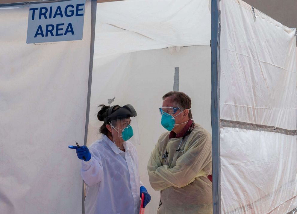 PHOTO: Medical staff discuss a patient's symptoms inside a Covid-19 testing center at the Navajo Nation town of Monument Valley in Arizona, May 21, 2020.