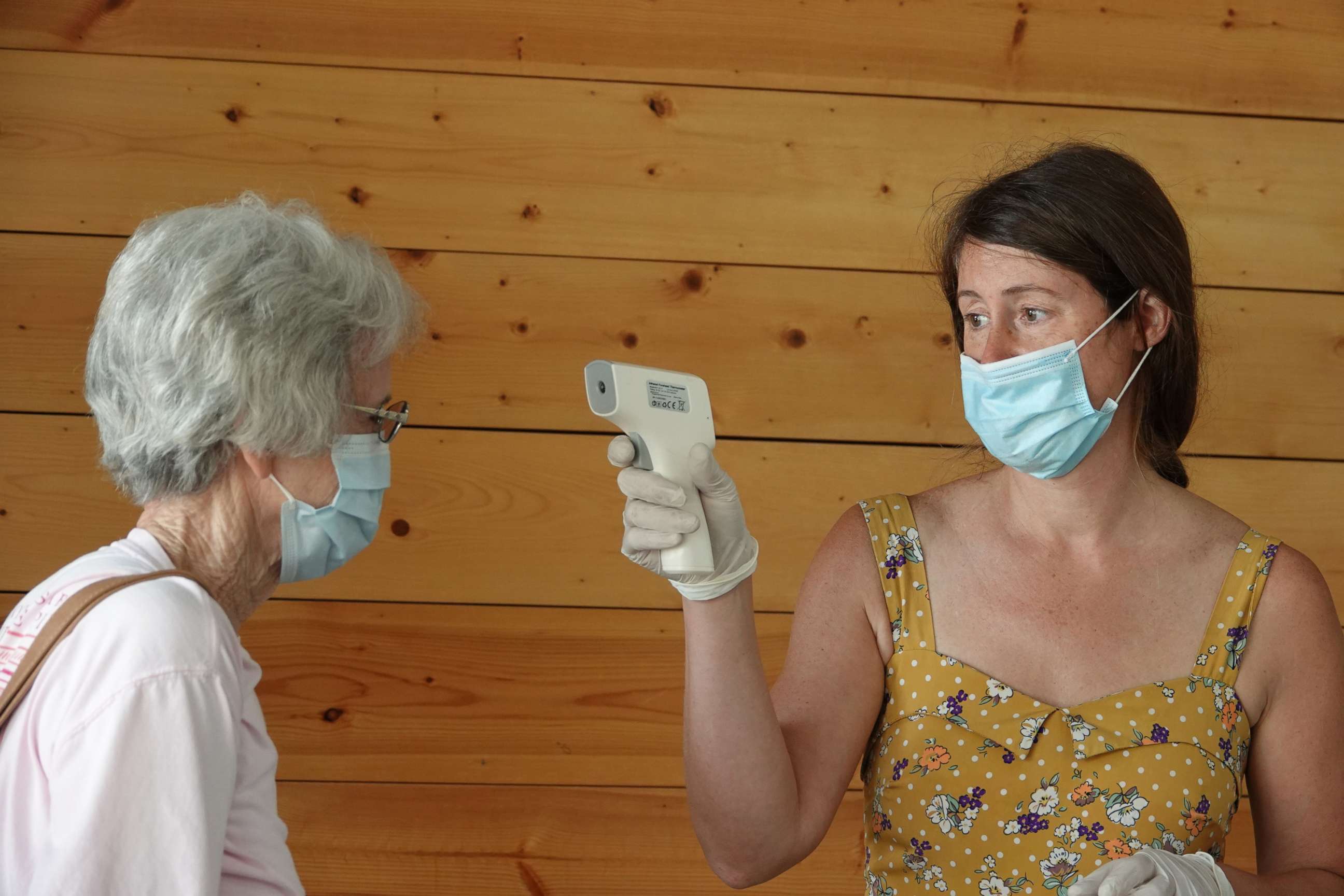 PHOTO: Jill Forrester takes temperatures and enforces the wearing of face masks at a farmers market in Wilson, Ark., to ensure the safety of customers, as the COVID-19 pandemic moves into rural Arkansas, July 15, 2020.