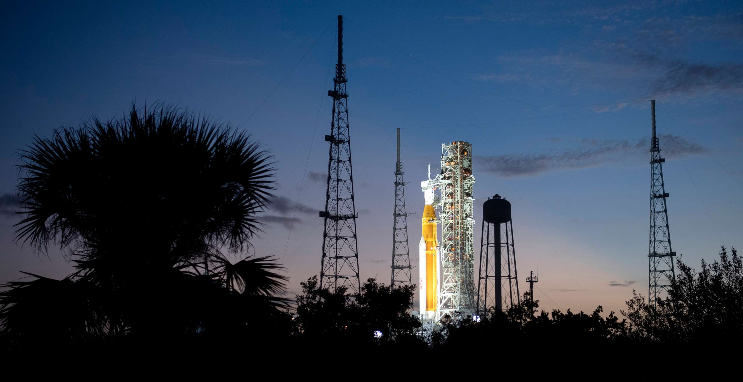 PHOTO: NASA's Space Launch System (SLS) rocket with the Orion spacecraft aboard is illuminated by spotlights after sunset atop the mobile launcher at Launch Pad 39B as preparations for launch continue, Nov. 6, 2022.