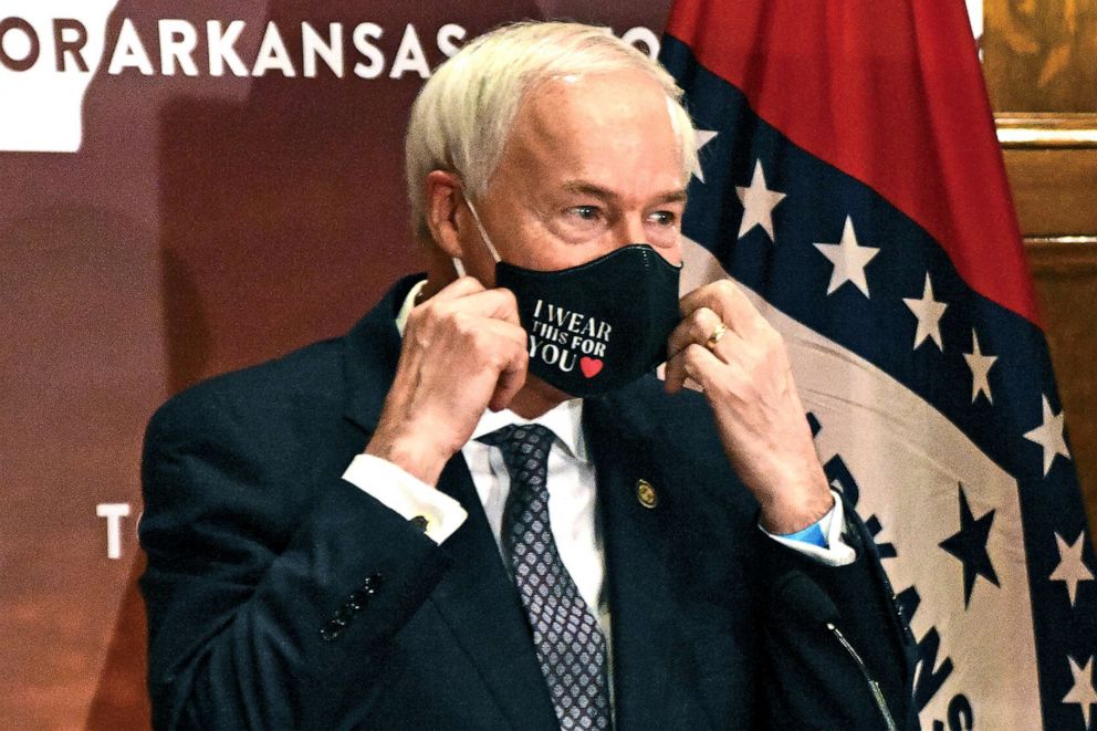 PHOTO: Gov. Asa Hutchinson removes his mask before a briefing at the state capitol, July 20, 2020, in Little Rock, Ark.